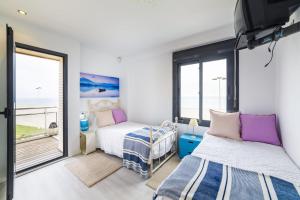a bedroom with two beds and a balcony at Fantastic penthouse 270m2 with amazing sea views in Roquetas de Mar