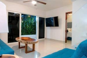 a living room with a blue couch and a table at Luxury and Comfort in the heart of Vallarta in Puerto Vallarta