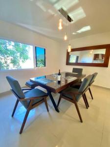 a dining room with a table and two chairs at Luxury and Comfort in the heart of Vallarta in Puerto Vallarta