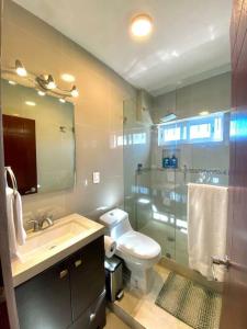 a bathroom with a toilet and a sink and a shower at Luxury and Comfort in the heart of Vallarta in Puerto Vallarta