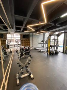 a gym with several treadmills and exercise bikes at Lux 2 bedroom apartment, swimming pool, gym and free parking spot in Macro Plaza area in Monterrey