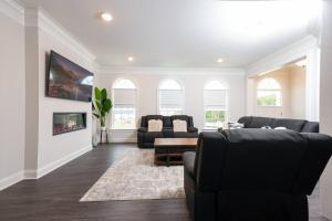a living room with black chairs and a table at Comfort Plus in Woodbridge
