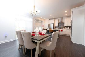 a kitchen and dining room with a table and chairs at Comfort Plus in Woodbridge