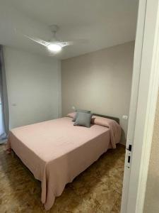 una camera da letto con un grande letto con lenzuola rosa di Altemar, two bedrooms las americas ad Arona