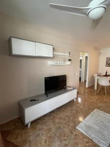 a living room with a flat screen tv at Altemar, two bedrooms las americas in Arona