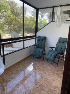 two chairs sitting in a room with windows at Altemar, two bedrooms las americas in Arona