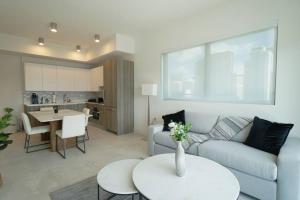 a living room with a couch and a table at Brand New Apartment in Brickell with parking in Miami