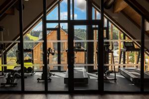 an open gym with a large window and tread machines at Aldrov Resort in Vítkovice