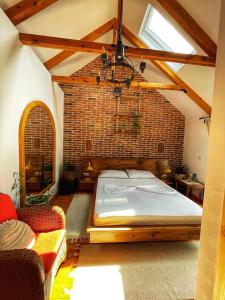 a bedroom with a large bed in a brick wall at House 1960 in Lin