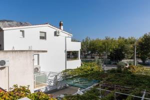 an aerial view of a white building with a garden at Apartments with parking space Omis - 2745 in Omiš