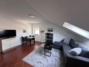 a living room with a couch and a table at Cozy apartment in the Sauerland in Brilon