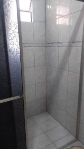 a bathroom with a shower with a glass door at Casa Gil in Foz do Iguaçu