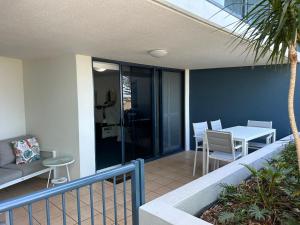 a patio with a table and chairs on a balcony at Prime Position – Dream Holiday Unit in Caloundra!! in Caloundra