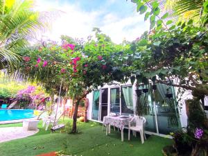 a garden with a table and chairs and a pool at OASIS Phuket Airport in Ban Bo Sai Klang