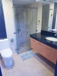 a bathroom with a shower and a toilet and a sink at Luxury Budget Condo in Central Cebu in Cebu City