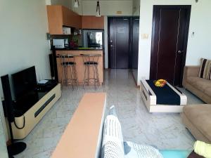 a living room with a couch and a tv at Luxury Budget Condo in Central Cebu in Cebu City +8 photos