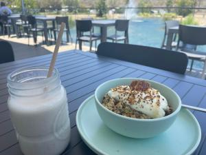 a bowl of food and a glass of milk on a table at Townsville Eco Resort 