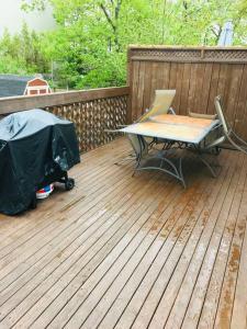 a patio with a table and chairs on a deck at Armdale Urban Lodge, Dine & Stay in Halifax