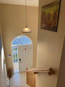 a hallway with a white door and an arched window at Armdale Urban Lodge, Dine & Stay in Halifax