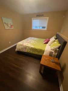 a small bedroom with a bed and a table at Armdale Urban Lodge, Dine & Stay in Halifax
