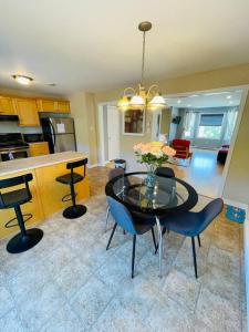 a kitchen and dining room with a table and chairs at Armdale Urban Lodge, Dine & Stay in Halifax