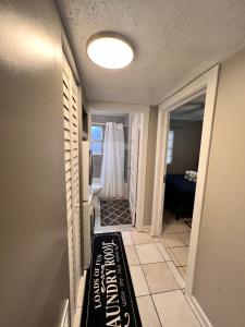 a hallway with a door with a shower curtain at Cozy 2BR Home Near Shands Hospital, UF, and Downtown Gainesville in Gainesville