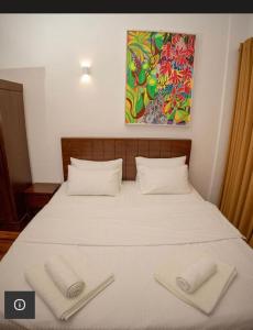 a bedroom with a bed with two towels on it at Avenue Nuwara Eliya in Nuwara Eliya