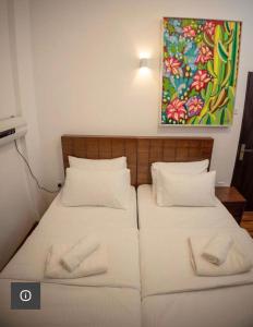 dwa łóżka w pokoju z obrazem na ścianie w obiekcie Avenue Nuwara Eliya w mieście Nuwara Eliya