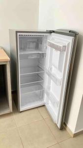 an empty refrigerator with its door open in a kitchen at Departamento Nuevo Cd Madero Cerca a playa Miramar in Ciudad Madero