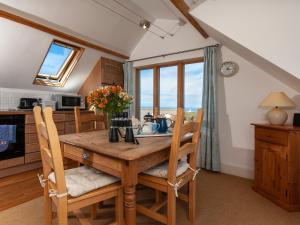 a kitchen and dining room with a wooden table and chairs at Lighthouse Watch in Saint Nicholas