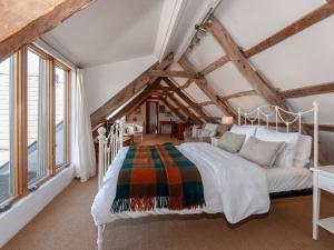 a bedroom with a white bed and large windows at Lighthouse Watch in Saint Nicholas