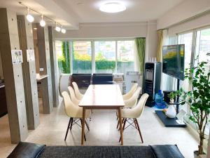a dining room with a table and chairs at O2 capsule house OTARU in Otaru