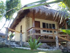 a house with a thatched roof at Tepanee Beach Resort in Malapascua Island