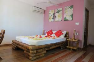 a bedroom with a bed in a room with pink walls at Tepanee Beach Resort in Malapascua Island