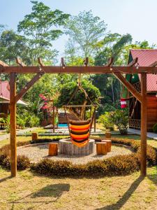 an orange hammock swing in a park at Aroldo Amazon Lodge in Puerto Maldonado