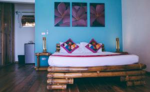 a bedroom with a bed made out of logs at Tepanee Beach Resort in Malapascua Island