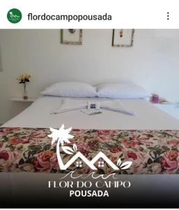 a poster of a bed with a floral bedspread and a sign at Pousada Flor do Campo in Icapuí