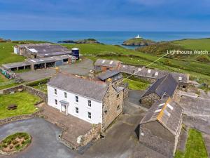 an aerial view of a building with the ocean in the background at Lighthouse Watch in Saint Nicholas