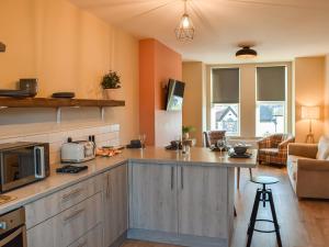 a kitchen with a counter top and a living room at Apartment Two - Uk45353 in Southport