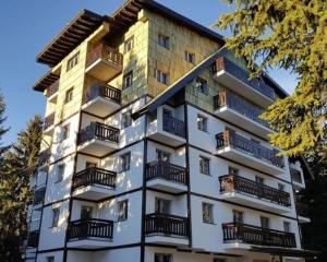 a tall building with balconies on the side of it at Vila Zvončica Apartman Z12 in Kopaonik