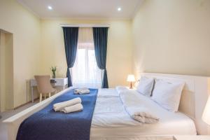 um quarto com uma cama grande e toalhas em Old Town-Booking Apartment em Tbilisi