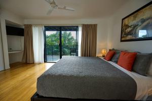 a bedroom with a large bed and a large window at Shorelines in Hamilton Island