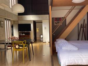 a bedroom with a bed and a table and a dining room at naramachiの宿 自助入住 请看邮件 in Nara