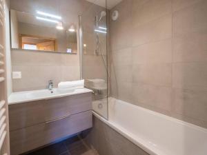 a bathroom with a tub and a sink and a shower at Appartement Valmorel, 3 pièces, 6 personnes - FR-1-291-1003 in Valmorel