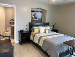 a bedroom with a large bed and a bathroom at Oceana Casa Del Mar in Rosarito