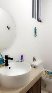 希克蘇魯伯的住宿－Chicxulub Puerto Beach Penthouse，浴室配有白色水槽和卫生间。