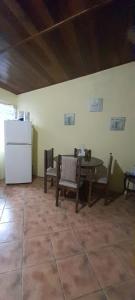 a kitchen with a table and chairs and a refrigerator at Casa Mora in Jacó