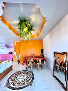 a room with a table and chairs and a ceiling at Heaven Guesthouse in Pakse