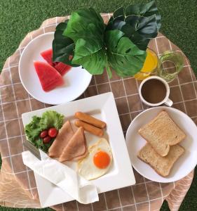three plates of breakfast foods on a table at Chuencheewa Resort in Pattaya South