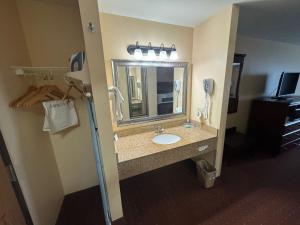 ein Bad mit einem Waschbecken und einem Spiegel in der Unterkunft Americas Best Value Inn Saint Robert/Fort Leonard Wood in Saint Robert